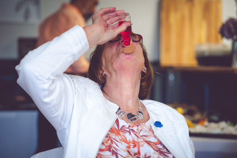 Guest drinking wedding favour in Liverpool by Northwest Wedding Photographer Adam Edwards